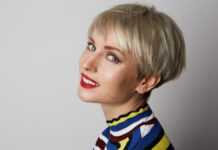 Chic Pixie Haircuts: The Expert’s Guide to Styling Short Woman showcasing a chic pixie haircut with soft face-framing layers and glossy finish.