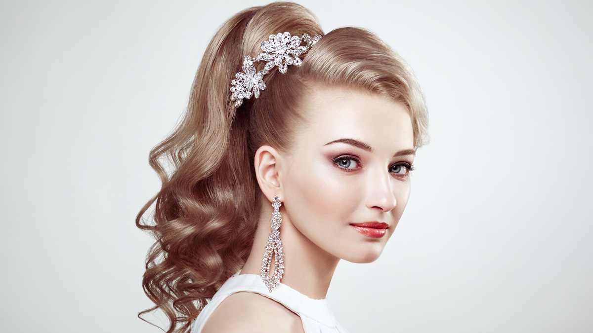 Stunning bride wearing a bohemian half-up half-down wedding hairstyle with delicate braids.