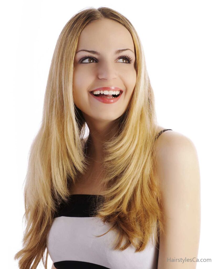 Woman with long dark straight hair featuring face-framing layers starting at the chin