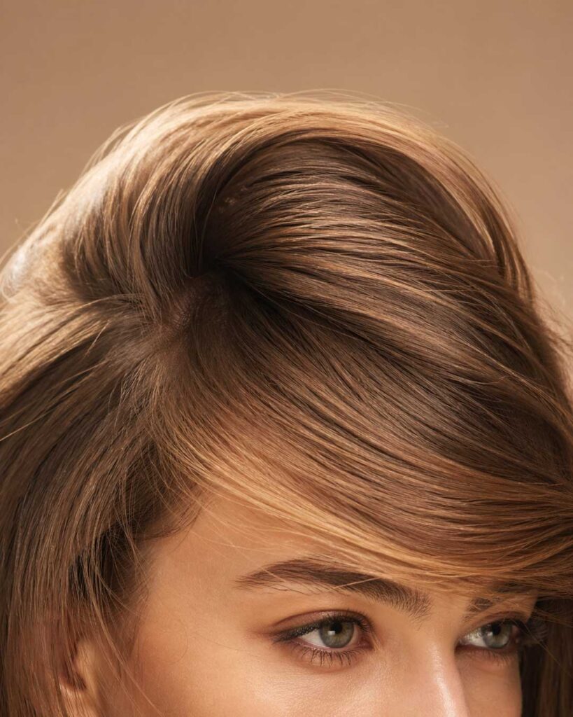 Close-up of voluminous side-swept fringe for triangle faces.