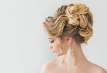 Wedding Updo Hairstyles: Your Guide to Timeless Bridal Elegance Close up of a highly structured and romantic updo wedding hairstyle with soft tendrils.