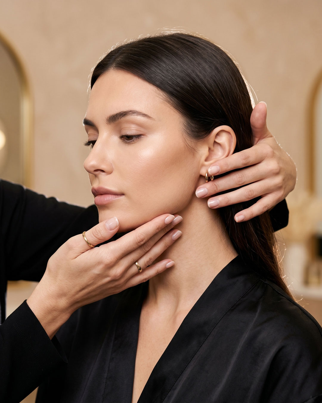 Stylist measuring facial thirds and malar bones for a custom haircut.